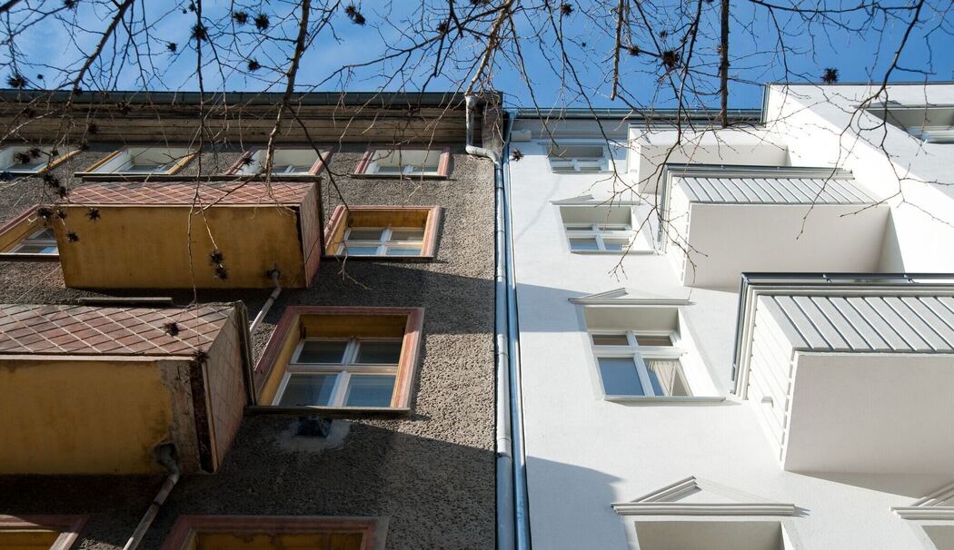 Ein unsaniertes Mehrfamilienhaus neben einem sanierten Haus Ein unsaniertes Mehrfamilienhaus neben einem sanierten Haus